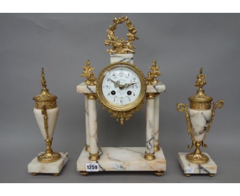 A French marble and gilt metal mounted mantel three piece clock garniture, late 19th century, the drum case supported by four