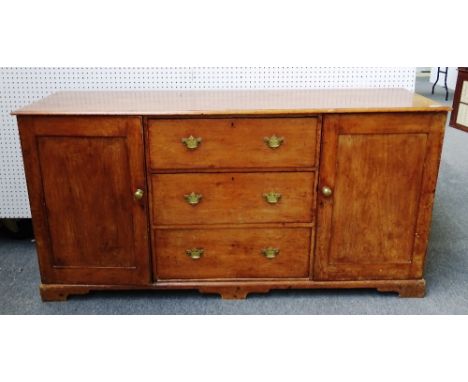 A 19th century pine dresser base, with three central drawers flanked by cupboard, on bracket feet, 186cm wide x 94cm high x 5