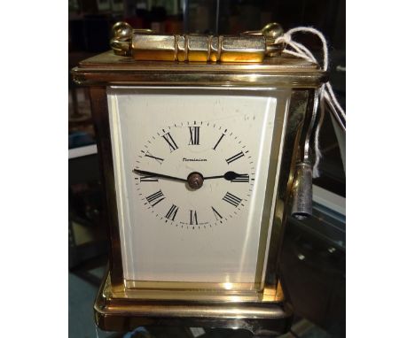 An early 20th century cased carriage clock with key. 12cm tall   CAB