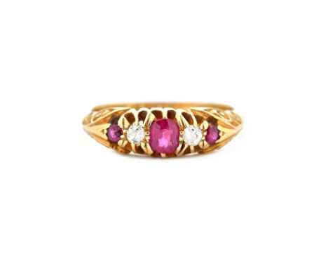 An 18ct gold, ruby and diamond set five stone ring, mounted with three cushion shaped rubies, alternating with two cushion sh