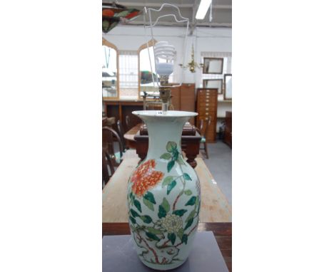 A Chinese porcelain baluster vase, late 19th/20th century, painted in famille-verte enamels with flowers and a pierced rock, 