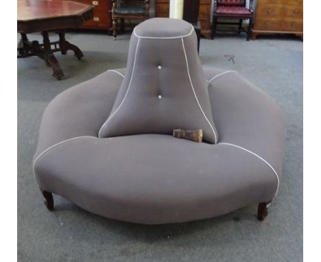 A large freestanding stool of shaped oval form, with raised lozenge shaped centre, 217cm long x 180cm deep.  M8