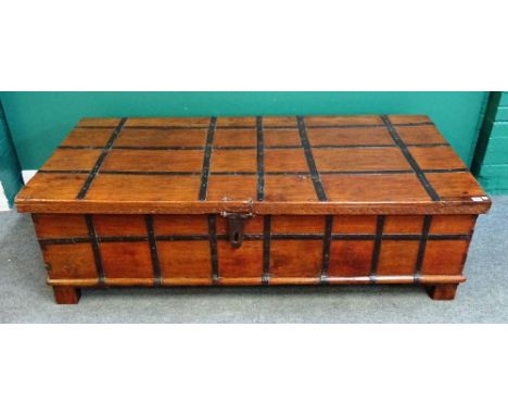 A large late 19th century Indian iron bound rectangular lift top trunk, on block feet, 170cm wide x 49cm high x 87cm deep.