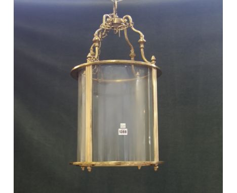 A Victorian style gilt metal hall lantern, 20th century, of circular form, with clear glass panels, 65cm high.