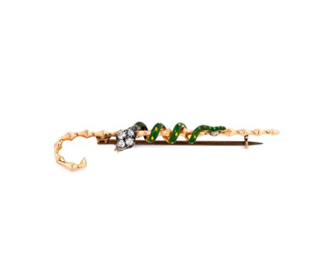 A gold, green enamelled and diamond set brooch, designed as a snake entwined around a simulated bamboo walking stick, the sna
