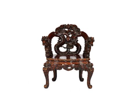 An early 20th century Chinese hardwood open armchair, the back relief carved as a pair of dragons chasing pearls, over solid 