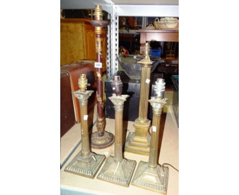 Lighting, comprising; four brass Corinthium column style table lamps and a wooden and gilt table lamp, 64cm tall (5)  S2B