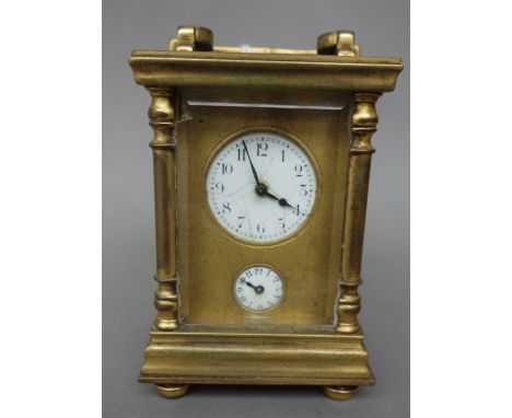 An early 20th century miniature brass cased carriage clock, with subsidiary alarm dial, a single train movement and a leather