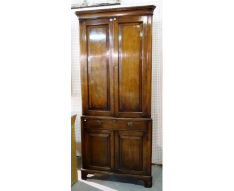 A mid-18th century mahogany double height corner cupboard, on bracket feet, 101cm wide x 125cm high.  M10