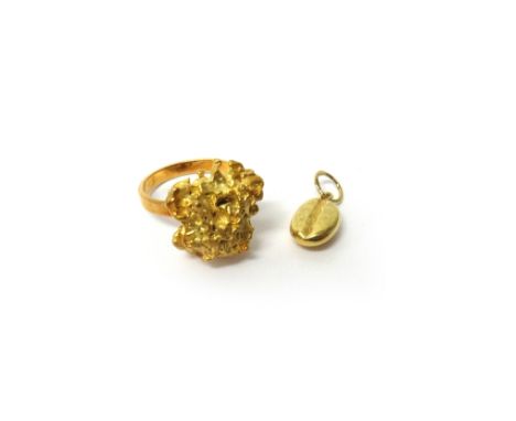 A French gold ring, cast as a nugget, ring size K and a half and a gold pendant, designed as a coffee bean, combined weight 1