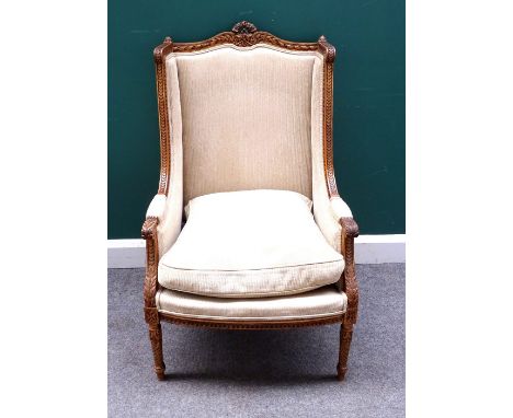 A Louis XV style gilt framed square wingback armchair, with bow seat on spiral fluted supports, 65cm wide x 109cm high.