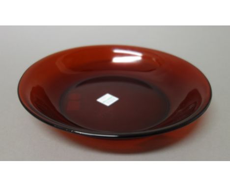 A Chinese ruby glass bowl, of shallow form with everted rim, 19cm. diameter. R & V. Tregaskis paper label to base.