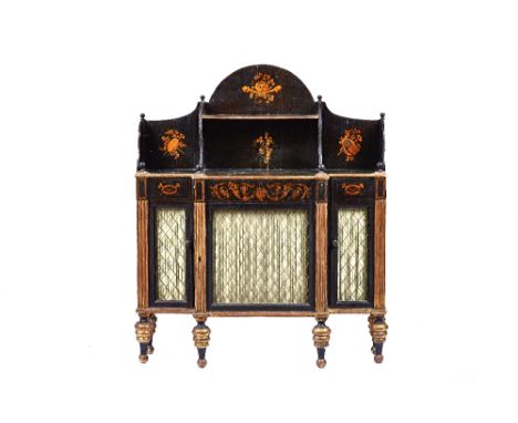 A Regency parcel gilt ebonised chiffonier, the shaped shelf back over single drawer and three grille doors, on turned support