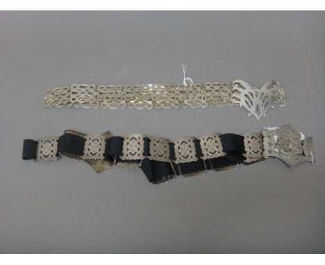 A lady's silver waistbelt, decorated with two portraits of ladies in an Art Nouveau design, otherwise with pierced floral dec