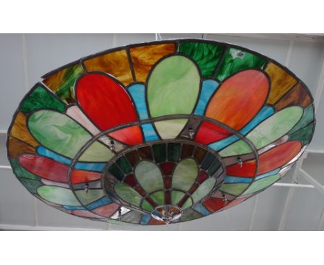 An Art Deco style coloured glass chandelier of large proportions, the polychrome foliate leaded panel of graduated circular f