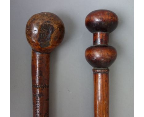 An unusual hardwood walking stick, probably African, late 19th century, with spherical carved pommel and matching knop, over 