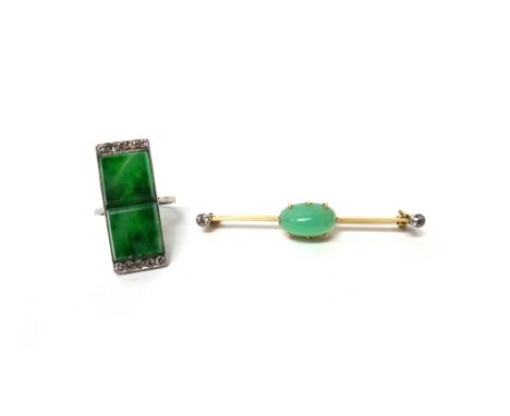 A diamond and simulated jade ring, of rectangular Art Deco design, mounted with two square cut simulated jades and with circu