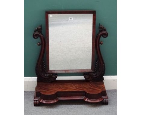 A Regency mahogany swing-frame toilet mirror with carved dolphin mounts on double bow front single drawer base, 68cm wide x 8