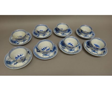 A set of eight Chinese blue and white teabowls and saucers, late 19th century, each painted with hunting scenes inside a chev