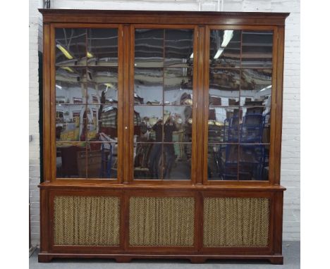 A George III and later mahogany bookcase cabinet, the dental cornice over three astragal glazed doors and three grille doors,