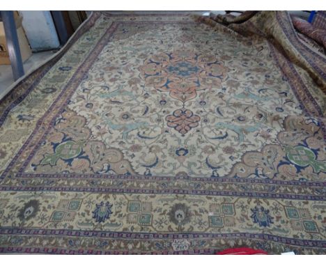 A Tabriz carpet, Persian, the ivory field with a bold apricot pole medallion, light brown spandrels, all with bold angular fl