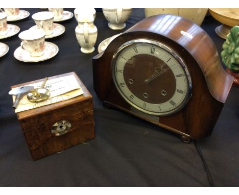 A tea caddy and mantel clock.