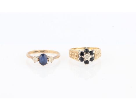 A hallmarked 9ct yellow gold sapphire and diamond flower design ring, with heart design shoulders, together with a blue and w