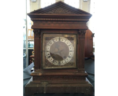A classical temple style mantel clock with brass face. Height 42.5cm.