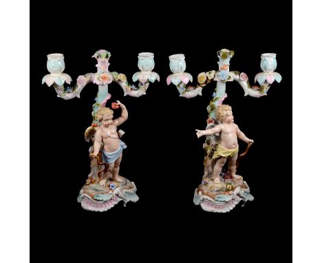 Pair of Continental porcelain twin-light candelabra, the scrolled branches with applied flowers raised on a floral stem, each