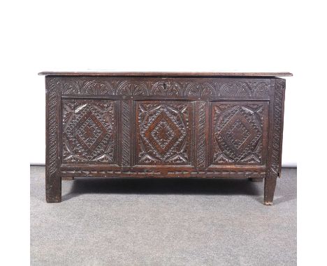Joined oak coffer, later carved with three panels of lozenge design, leaf motif borders, width 114cm, depth 50cm, height 62cm