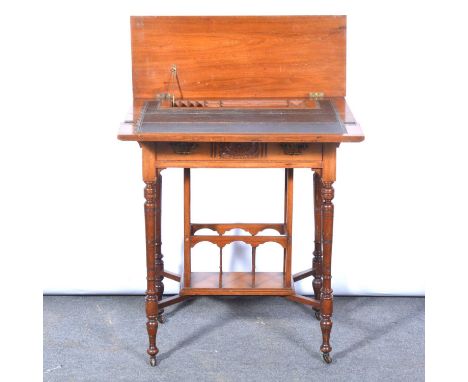 Victorian walnut writing table, folding top enclosing a writing surface and compartments, frieze drawer, the turned legs join