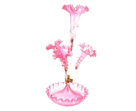 Victorian cranberry glass epergne, the central flute surrounded by three smaller flutes, overall height 54cm.