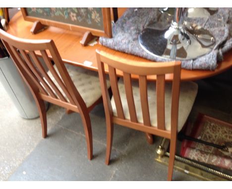 A LIGHT WOOD DINING TABLE AND CHAIRS