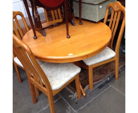 A LIGHT WOOD TABLE AND FOUR CHAIRS