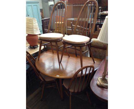 AN ERCOL DROP LEAF DINING TABLE AND FOUR CHAIRS