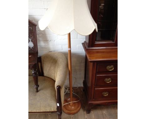 A LIGHT WOOD LAMP STANDARD