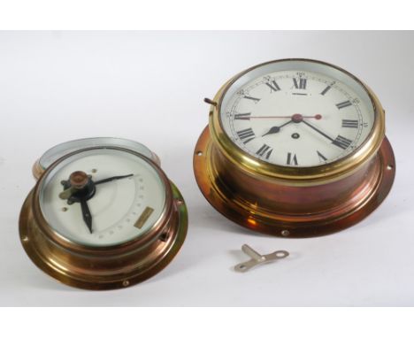 MID 20 CENTURY BRASS CASED SHIPS TYPE BULKHEAD CLOCK the white enamel Roman Made in England, with key the dial 8" (20.32 CM) 