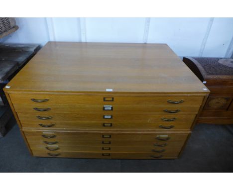 A light oak eight drawer plan chest 