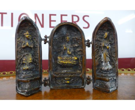 A small oriental bronze triptych 