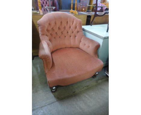 A Victorian mahogany and upholstered button back armchair 