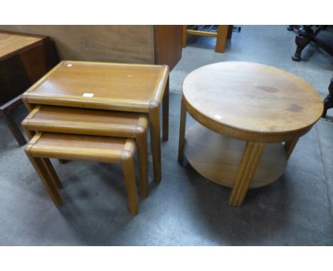 A teak nest of tables and a light oak circular coffee table 