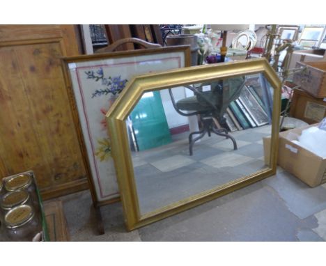 A gilt framed overmantle mirror and an oak embroidered firescreen 