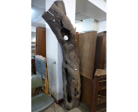 A large Asian tree trunk carving 