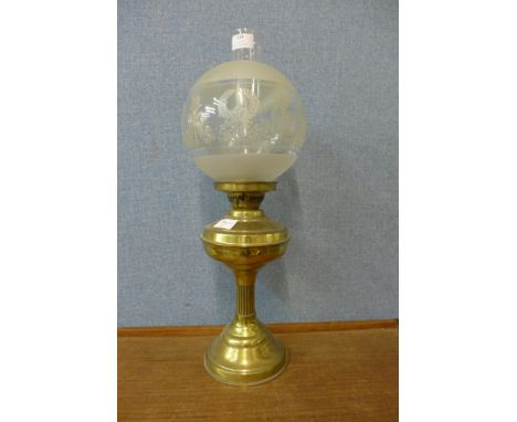 A Victorian brass oil lamp with etched glass shade 