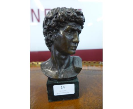 A small bronze bust of a Roman man, on green marble socle 