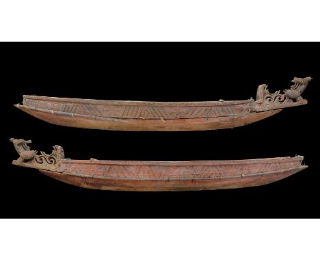 A RARE CARVED MAORI LARGE MODEL CANOE (WAKA), 19TH CENTURY formed of a hiwi  carved from a single piece of wood, fitted above