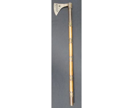 AN INDIAN AXE, 19TH CENTURY with iron head pierced with a series of slipped circles and inlaid with engraved brass and copper