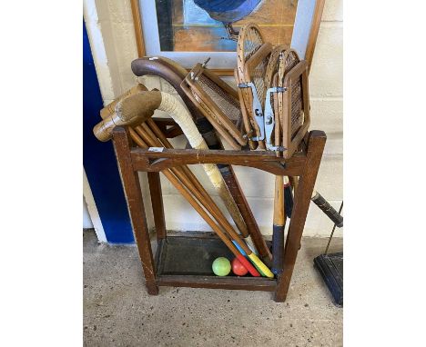 Stick stand containing vintage rackets, hockey sticks, croquet mallets etc