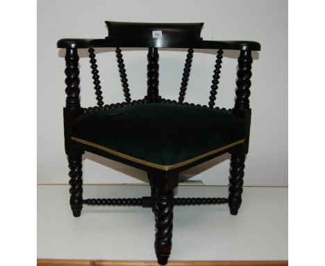 Early 20thC horseshoe corner armchair with barley twist and bobbin turned supports.