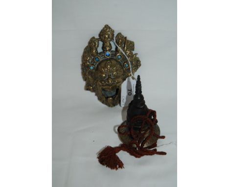 Asian demon head incense burner and an Asian metal ink pot on a sash.